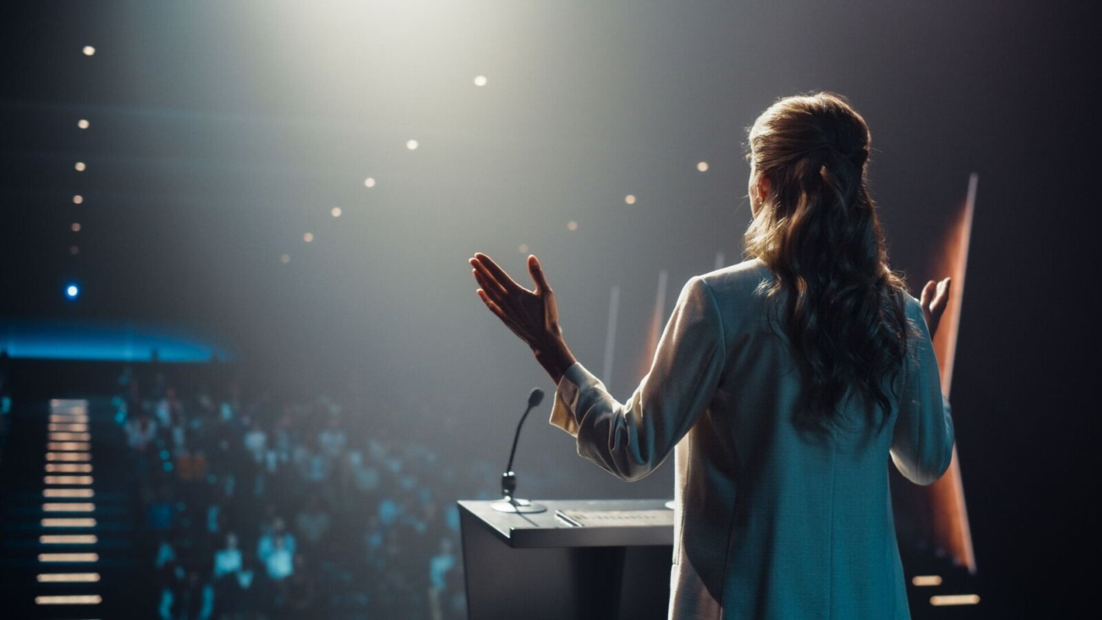 Female speaking to a crowd.