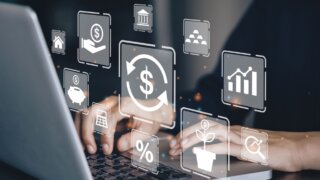 Person at desk with laptop displaying financial returns and information.