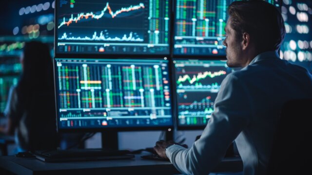Man at desk looking at financial data.