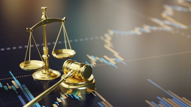 Gavel and golden scales with financial information below.